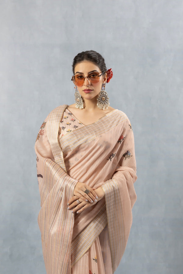 A stylish close-up of the model in sunglasses, wearing the Vanya Sarees pink striped linen saree.