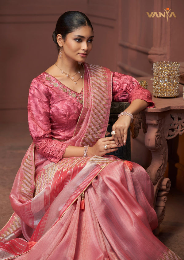 A beautiful seated portrait of the model in a Vanya Sarees pink Tussar silk saree, highlighting the designer puff sleeve blouse.