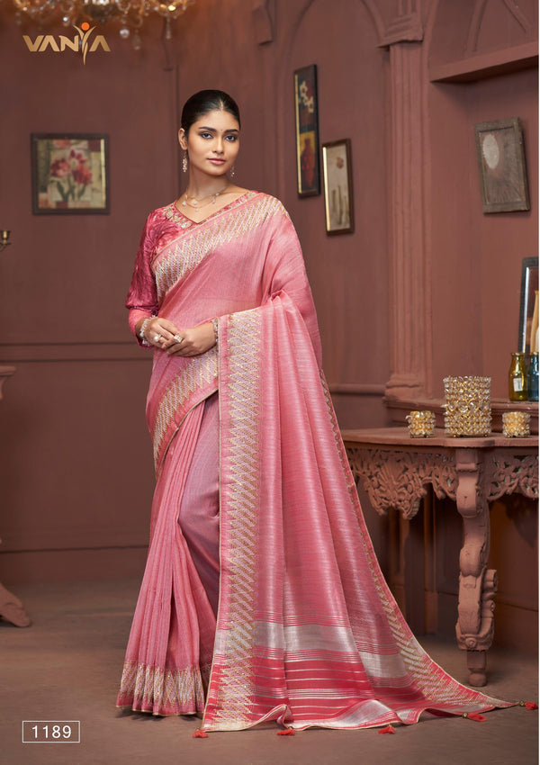 A full-length view of the model in Vanya Sarees' elegant rose pink Tussar silk saree with a contemporary chevron border.