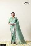 A full-length view of the model in Vanya Sarees' elegant pista green woven Chanderi silk saree with a designer blouse.