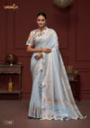 Model showcasing the complete Vanya powder blue linen silk saree, highlighting the elegant drape and the contrasting abstract print designer blouse.