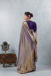 A full back view of the model in the Vanya Sarees ensemble, displaying the grand woven pallu and the purple designer blouse.