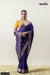 A full front view of the model in Vanya Sarees' magnificent royal purple Katan Banarasi silk saree with a contrasting yellow blouse.