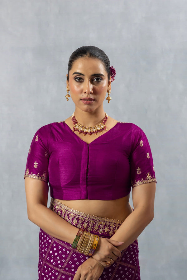 A clear front view of the Vanya Sarees readymade designer blouse in magenta purple, showing the V-neck and delicate sleeve embroidery.