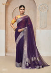 A full-length view of the model in Vanya Sarees' magnificent royal purple georgette saree with a heavy silver Banarasi border.
