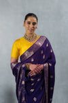 A close-up of the model wearing the Vanya Sarees purple georgette saree, highlighting the rich Banarasi border and designer blouse.