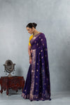 An elegant side profile of the model in the Vanya Sarees purple crushed georgette saree, showcasing its beautiful shimmer and drape.