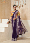 An elegant standing pose of the model showcasing the complete designer look of the Vanya Sarees purple georgette saree and floral blouse.