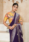 A beautiful close-up of the model in a Vanya Sarees purple saree, highlighting the rich, painterly floral print on the yellow designer blouse.
