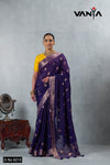A full-length view of the model in Vanya Sarees' regal purple and gold woven crushed georgette saree with a yellow designer blouse.