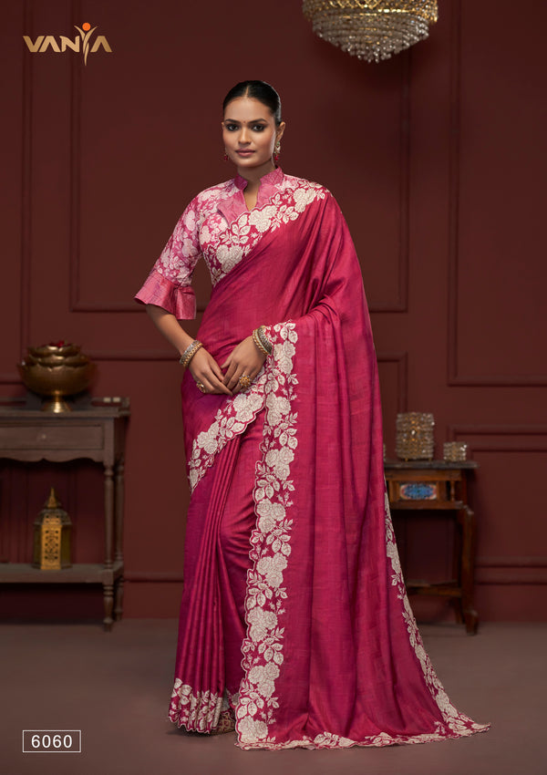 A full-length view of the model in Vanya Sarees' magnificent rani pink saree with a heavy, ivory embroidered cutwork border.