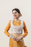 A clear view of the unique readymade blouse from Vanya Sarees, showing the yellow inner layer and the off-white embroidered outer jacket.