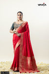 A full front view of the model in Vanya Sarees' magnificent bridal red Katan Banarasi silk saree with a contrasting green blouse.