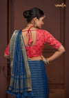 The stylish designer back of the red Bandhani print blouse from Vanya Sarees, featuring a dori tie-up and decorative tassels.