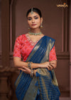 A beautiful close-up of the model in a Vanya Sarees saree, highlighting the rich Bandhani print and embroidered neckline of the designer blouse.