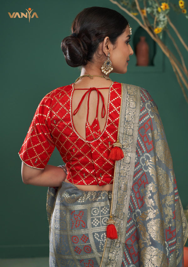 The stylish designer back of the red brocade blouse from Vanya Sarees, featuring a dori tie-up and tassel.