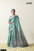 A full-length view of the model in Vanya Sarees' artistic sage green Tussar silk saree with a Madhubani-style print.
