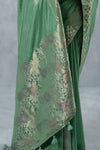 Detailed close-up of the multi-color floral Meenakari-style weaving on the pallu of the Vanya Sarees sage green silk saree.