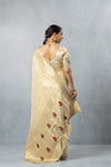 Vanya Champagne Gold Saree back view, highlighting the low-cut back of the blouse and the heavy zari pallu with red-accented paisley motifs.