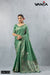 Official catalogue image for Vanya Sarees (D.No 7272) featuring a model in an elegant sage green silk saree with multi-tonal floral weaving.