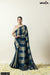 A full front view of the model in Vanya Sarees' modern teal blue and gold striped Katan Banarasi silk saree.