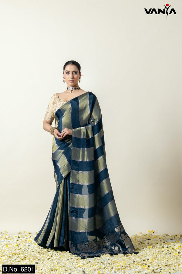 A full front view of the model in Vanya Sarees' modern teal blue and gold striped Katan Banarasi silk saree.
