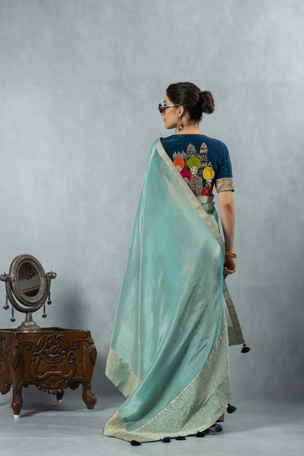 A full back view of the model in the Vanya Sarees ensemble, displaying the drape of the tissue silk pallu and the artistic embroidered blouse.