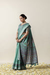 Model showcasing the graceful drape of the Vanya Sarees green Tussar silk saree with its rich, artistic print.