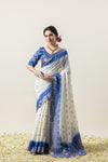 A full-length pose of the model showcasing the complete elegant look of the Vanya Sarees white and blue tie-dye Chanderi saree.
