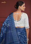 The stunning back of the white designer blouse from Vanya Sarees, showcasing the intricate mirror work on the neckline and sleeves.