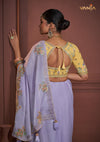 The stunning designer back of the yellow embroidered blouse from Vanya Sarees, featuring a stylish keyhole detail and dori tie-up.
