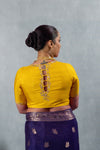 The unique designer back of the yellow blouse from Vanya Sarees, featuring an intricately embroidered keyhole detail.