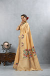 An elegant side profile of the model wearing the Vanya Sarees golden yellow silk saree, showcasing its beautiful drape and embroidered pallu.