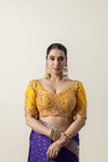 A clear front view of the Vanya Sarees heavy, hand-embroidered designer blouse in yellow, featuring a sweetheart neckline and intricate zardozi work.