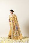 Three-quarter view of the model showcasing the graceful drape and artistic Pichwai pallu of the yellow linen silk Vanya Sarees.
