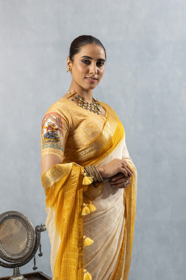 A close-up of the model wearing the Vanya Sarees yellow ombre saree, highlighting the designer blouse sleeve detail and rich fabric.