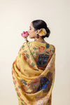 Model showcasing the detailed Shrinathji (Lord Krishna) Pichwai art on the pallu of the yellow Vanya Sarees linen silk saree.